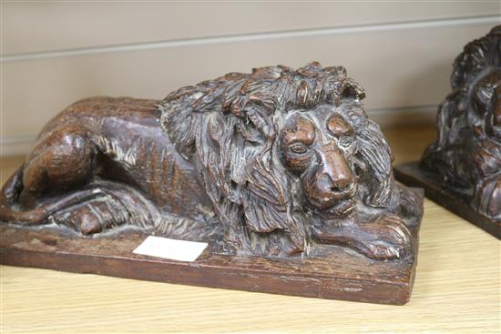 A pair of oak carvings of lions height 15cm width 37cm